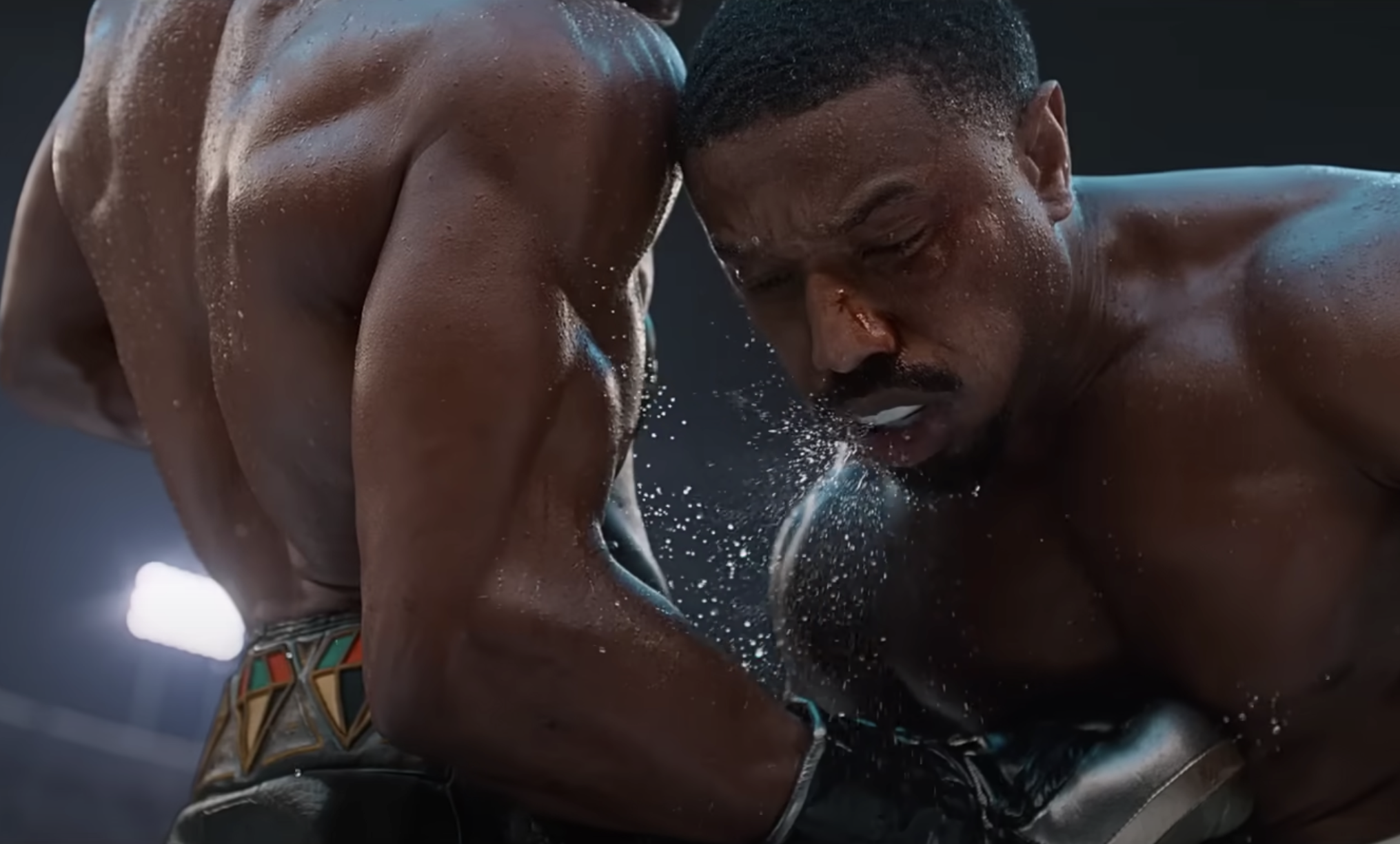 Michael B. Jordan and Jonathan Majors boxing in Creed III with the sweat flying off their bodies