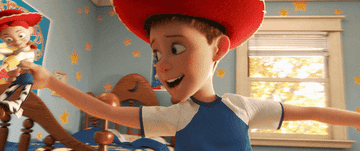 a gif of Andy in &quot;Toy Story&quot; twirling around with toys in each hand