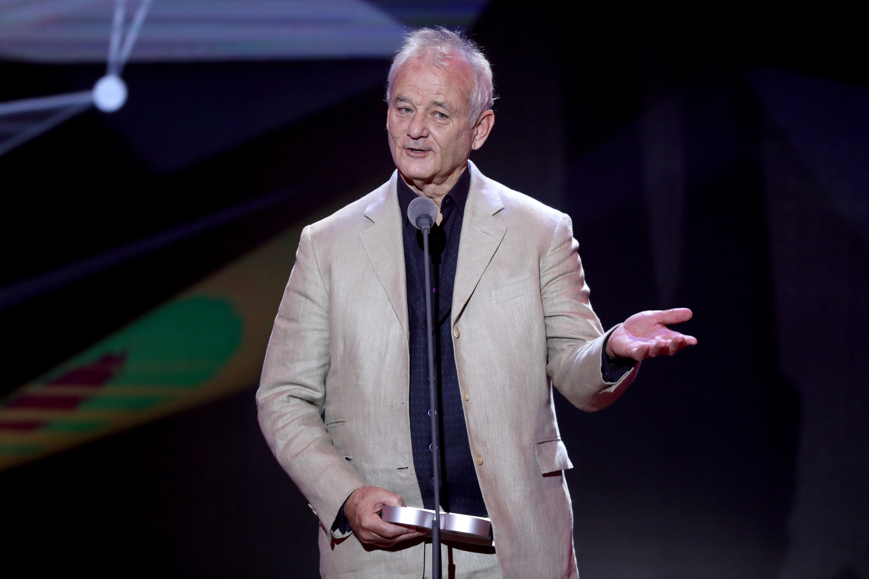 Bill Murray on stage speaking into a microphone