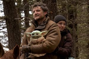 pedro pascal as joel in the last of us holding yoda grogru and ellie