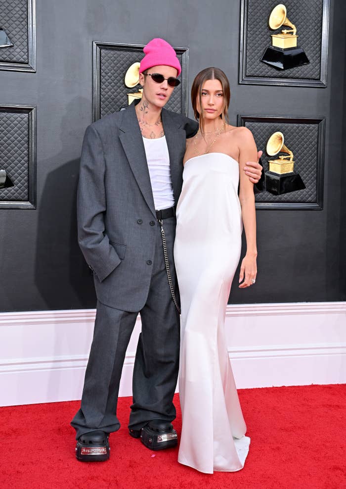 Justin with his arm around Hailey as they pose for photographers on the Grammys red carpet