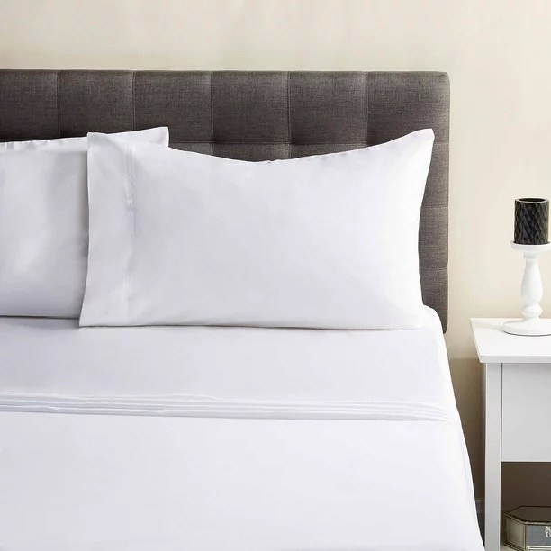 white cotton sateen sheets on a bed