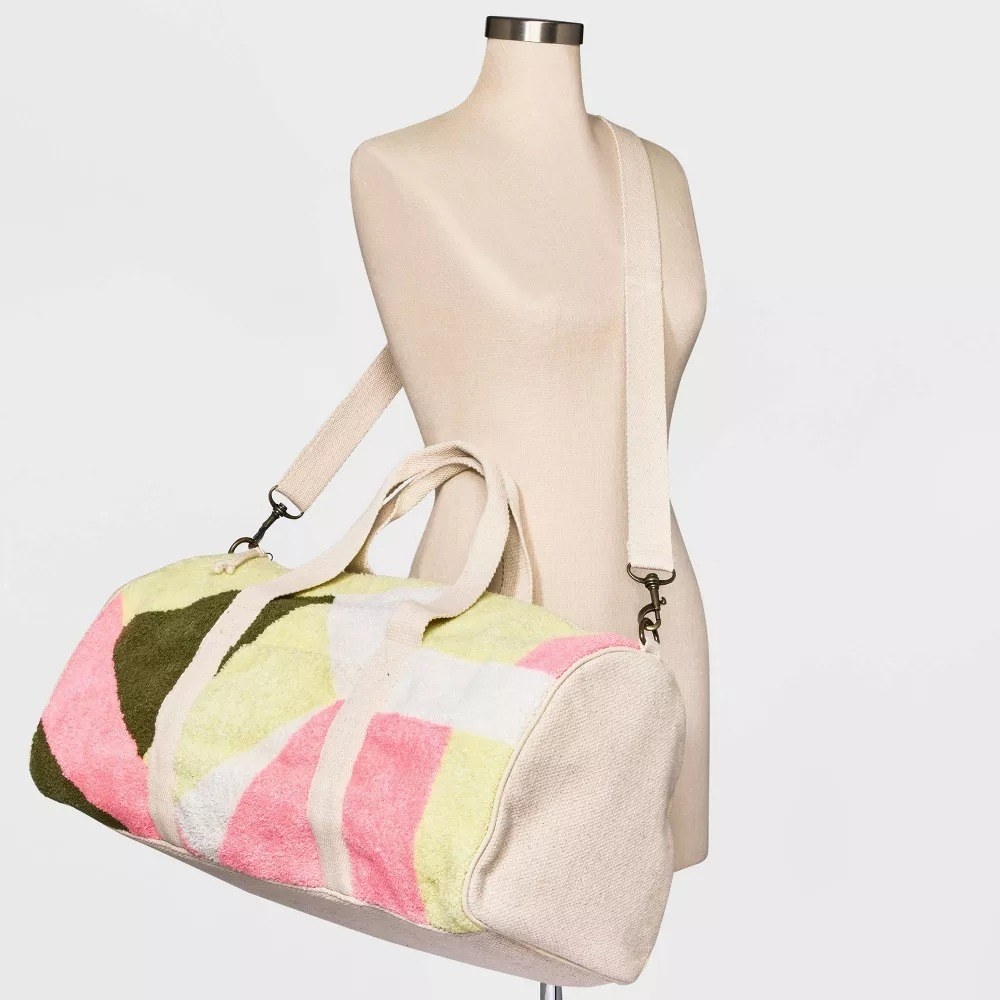 The tufted duffel bag on a mannequin