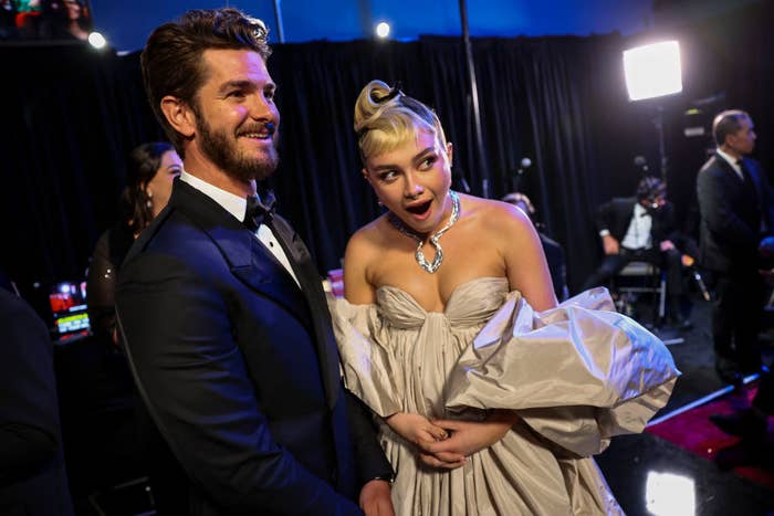 Andrew stands next to Florence, whose mouth is open in surprise