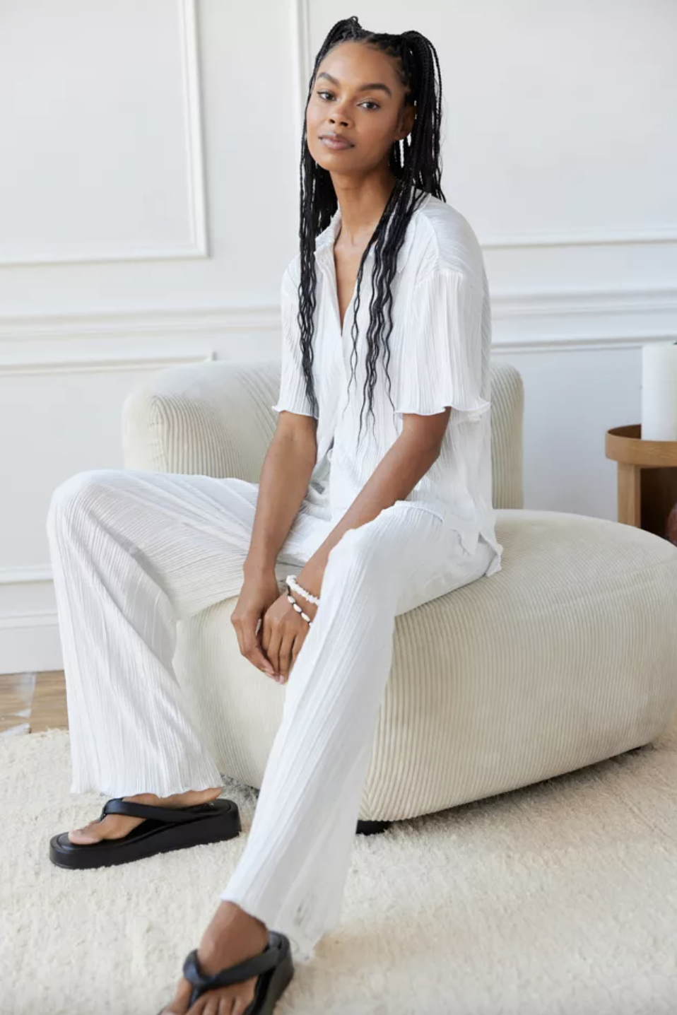 a person lounging in the plisse pants with a matching top