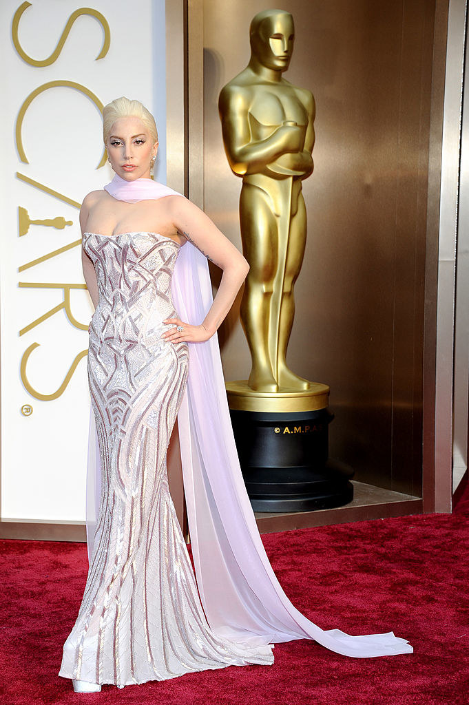 Gaga on the red carpet with an Oscar statue behind her