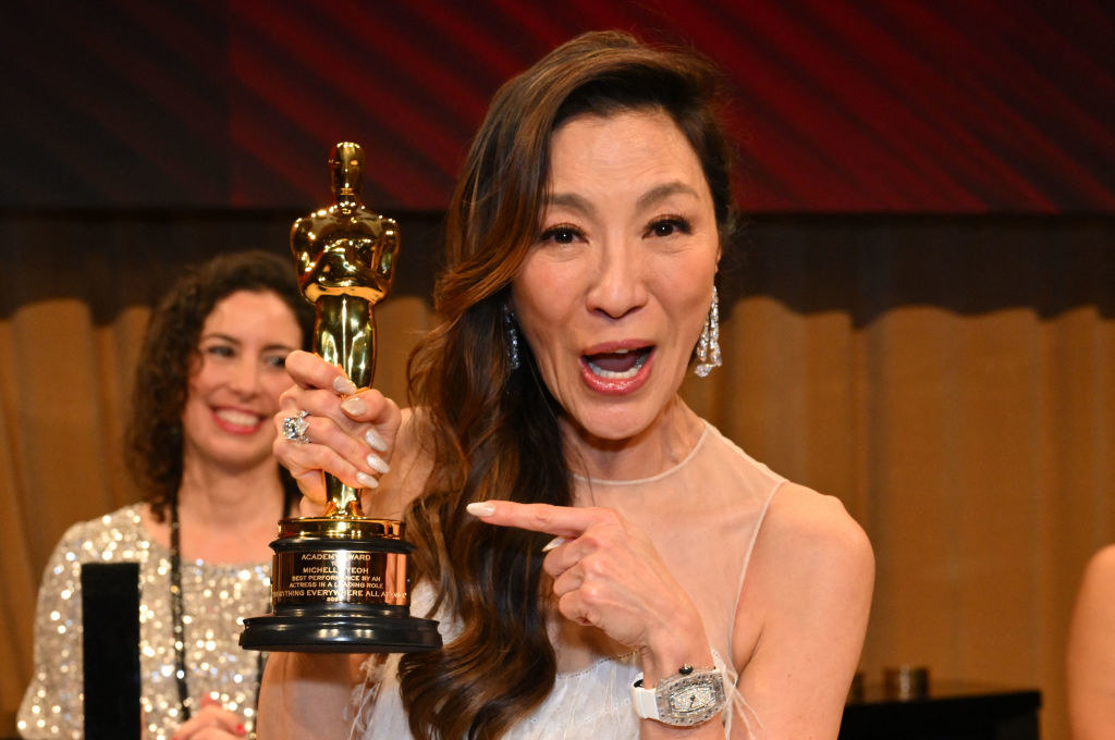 Michelle excitedly pointing at her award