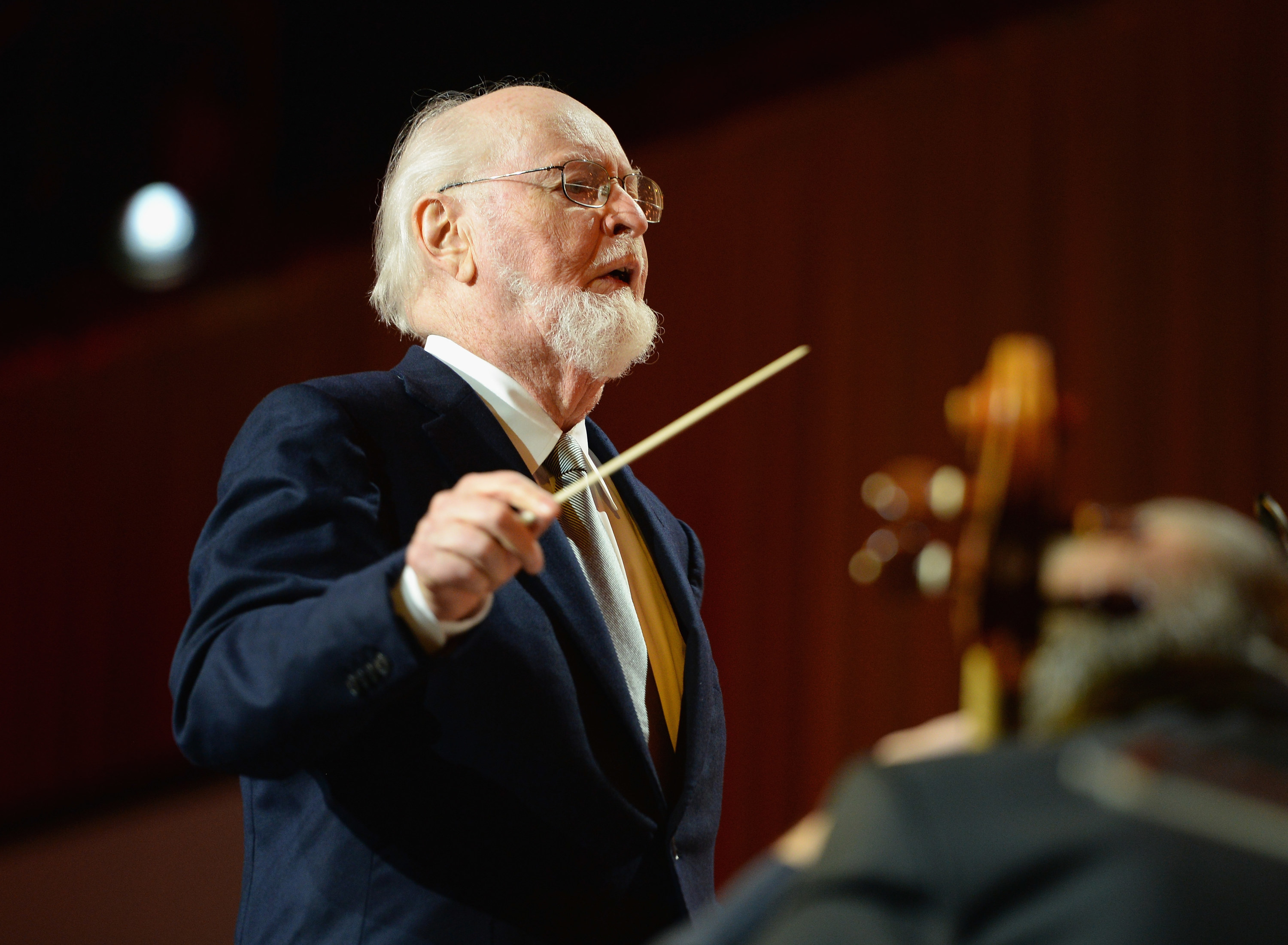 John Williams conducting an orchestra