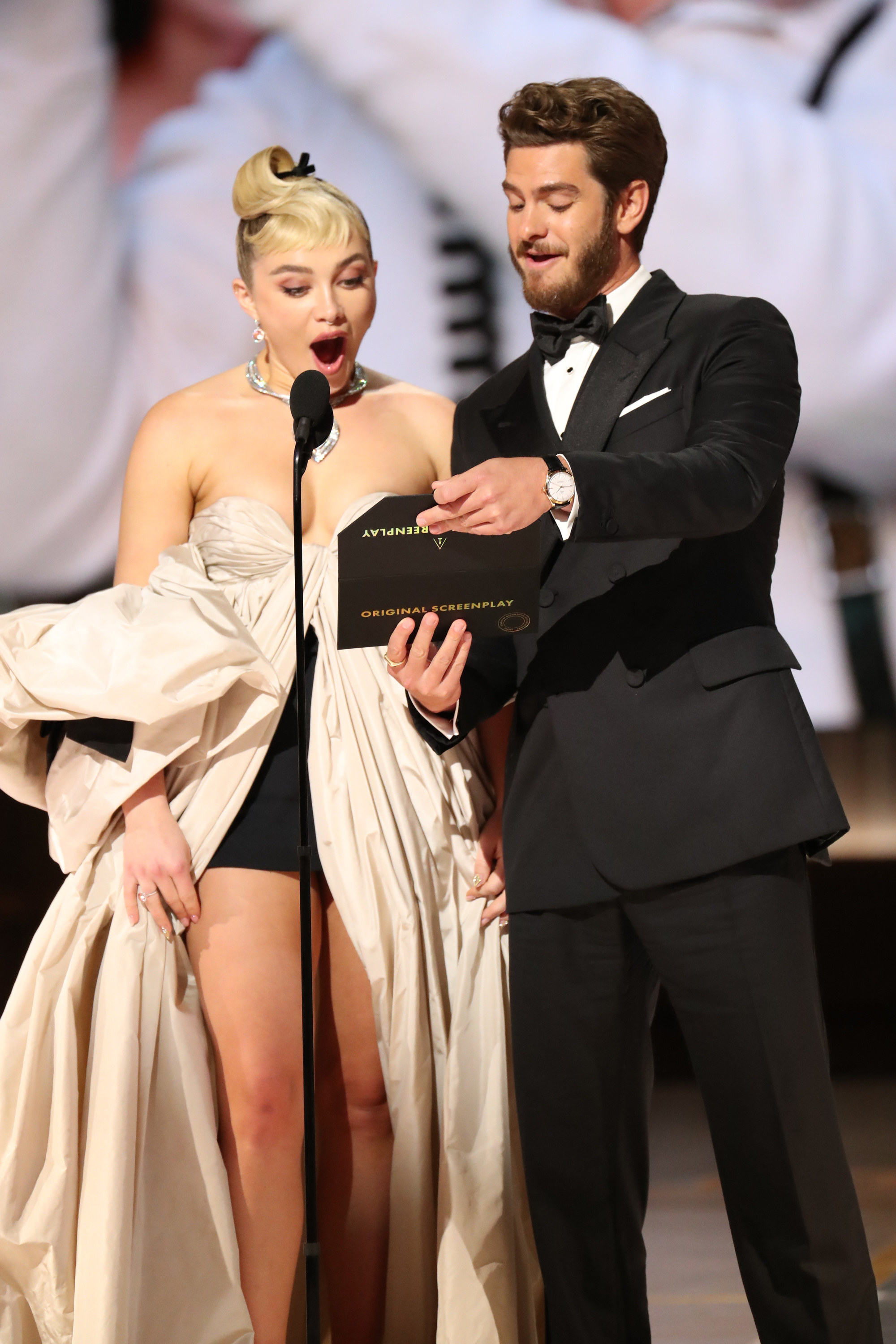 Florence Pugh and Andrew Garfield looking at the envelope with surprise on their face as they announce the winner