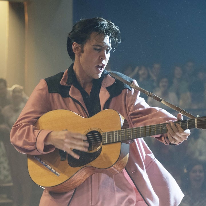 Austin Butler as Elvis playing the guitar and singing onstage in a scene from Elvis