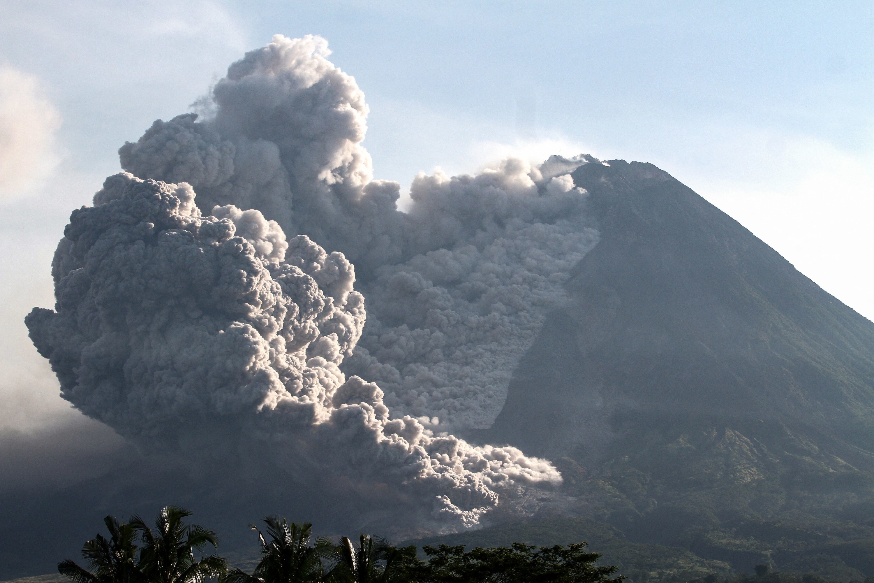 Mount Merapi continues to spew thick, billowing smoke and ash into the sky into the next day