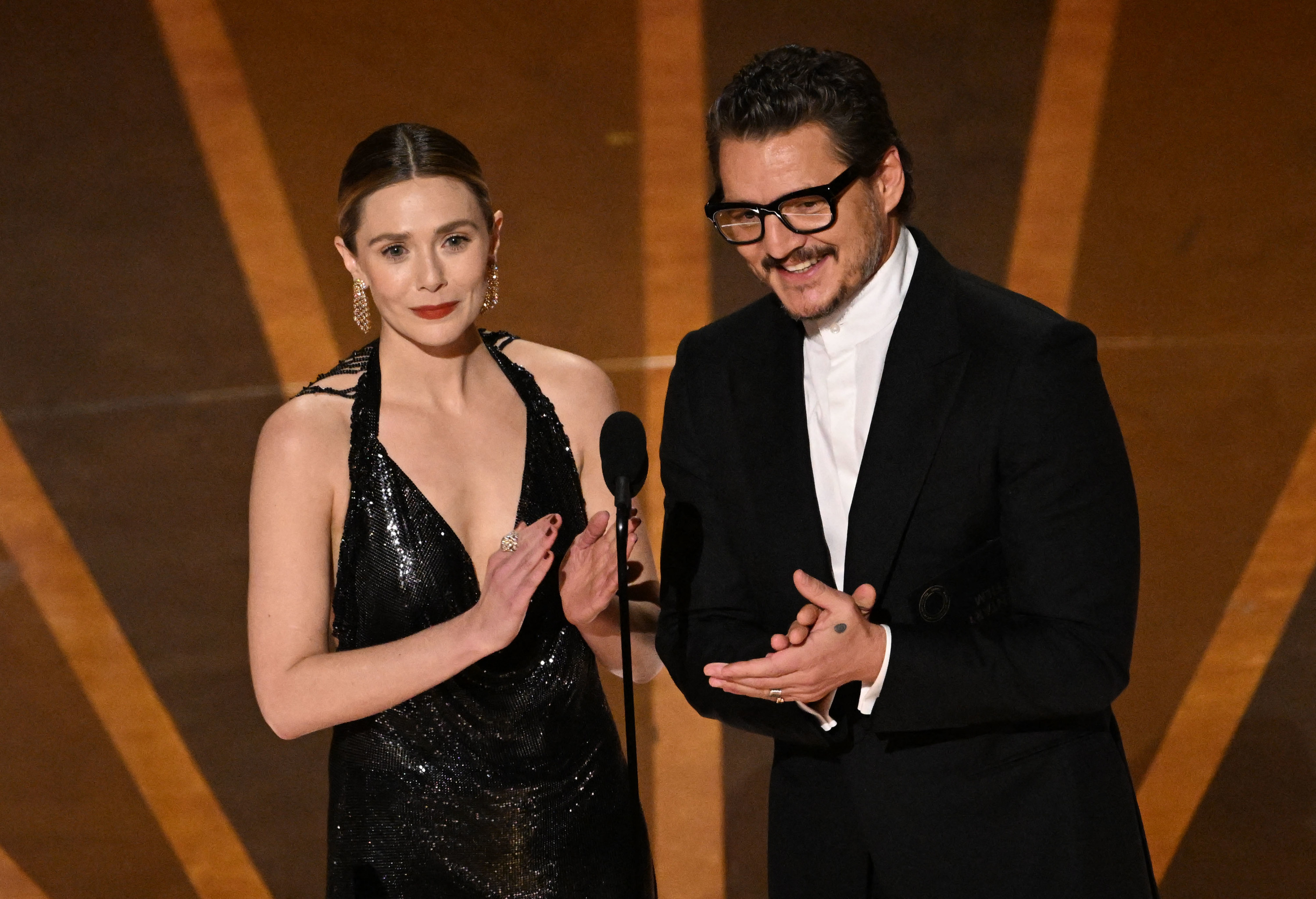 Elizabeth, on the left, claps as she and Pedro announce an award