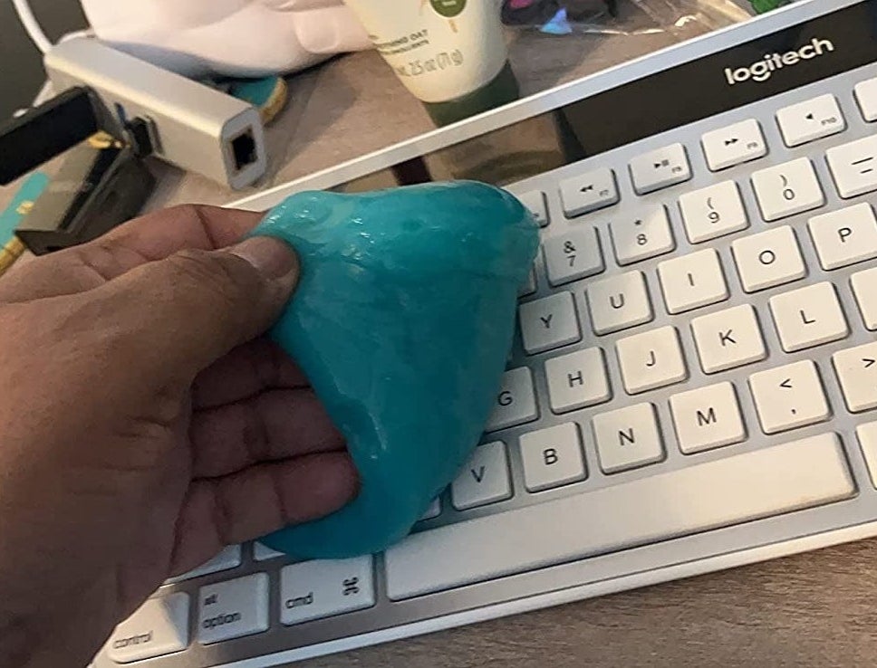 a reviewer using the blue putty on a computer keyboard