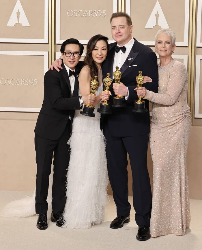 From left to right: Ke Huy Quan, Michelle Yeoh, and Brendan Fraser, and Jamie Lee Curtis pose together with their individual Oscar awards