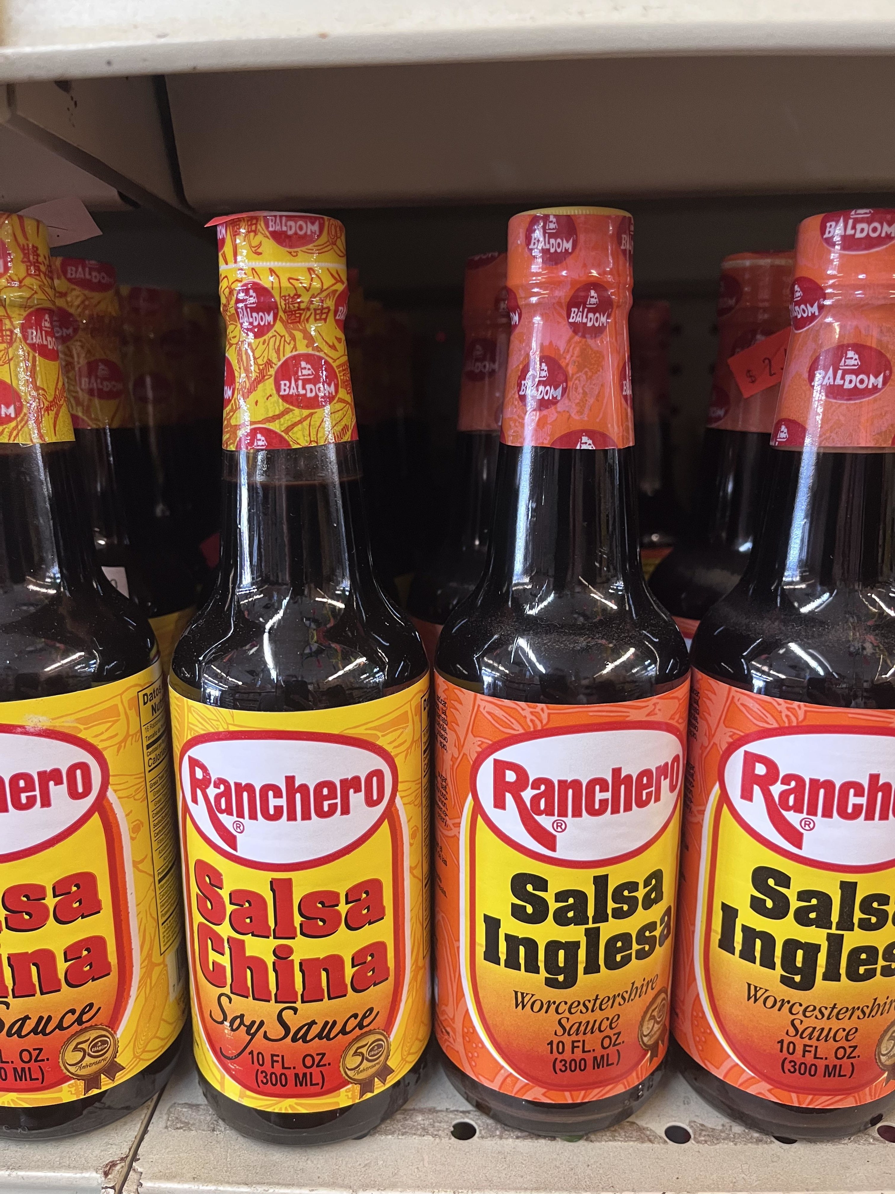 Bottles of salsa inglesa Worcestershire sauce and salsa China soy sauce on shelves