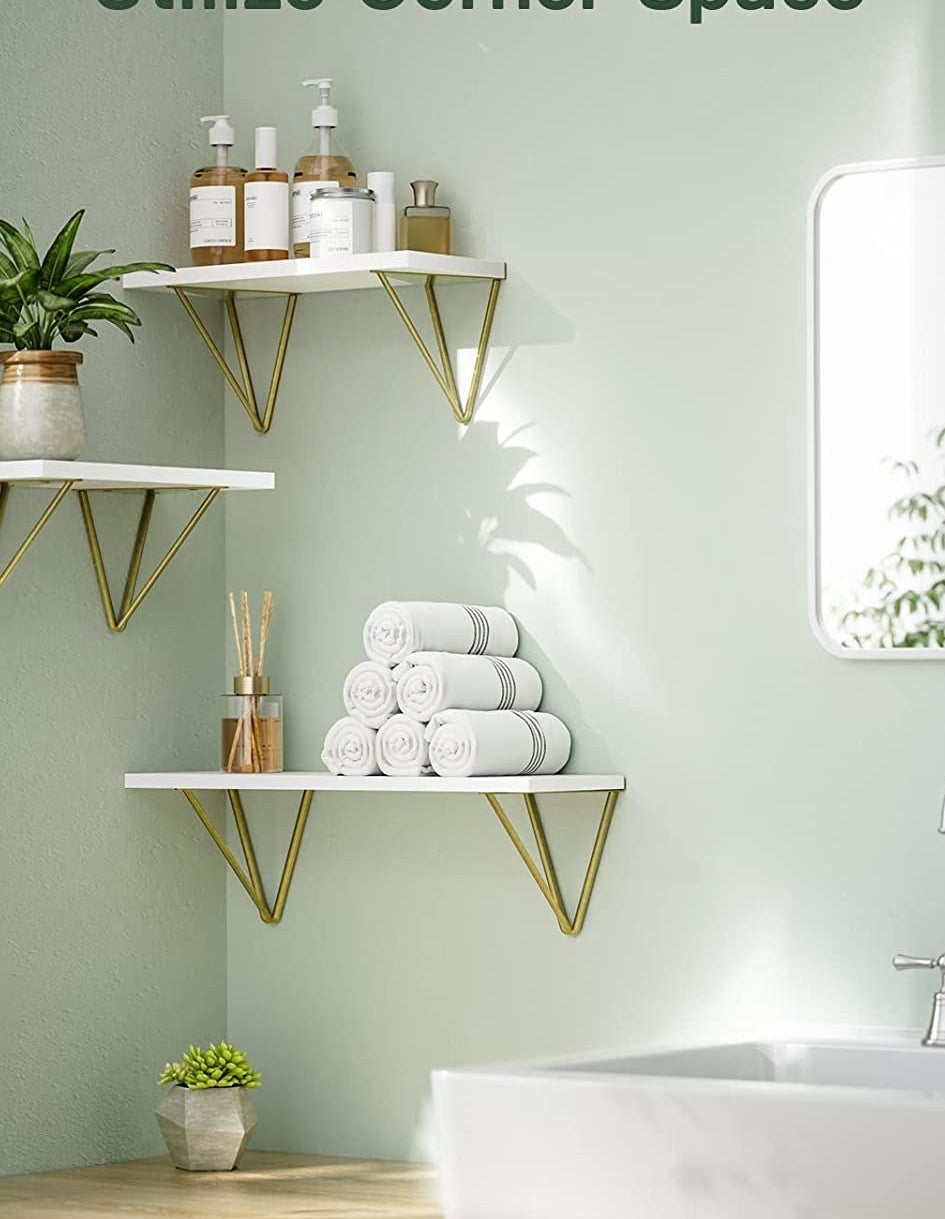 the floating shelves in the corner of a bathroom