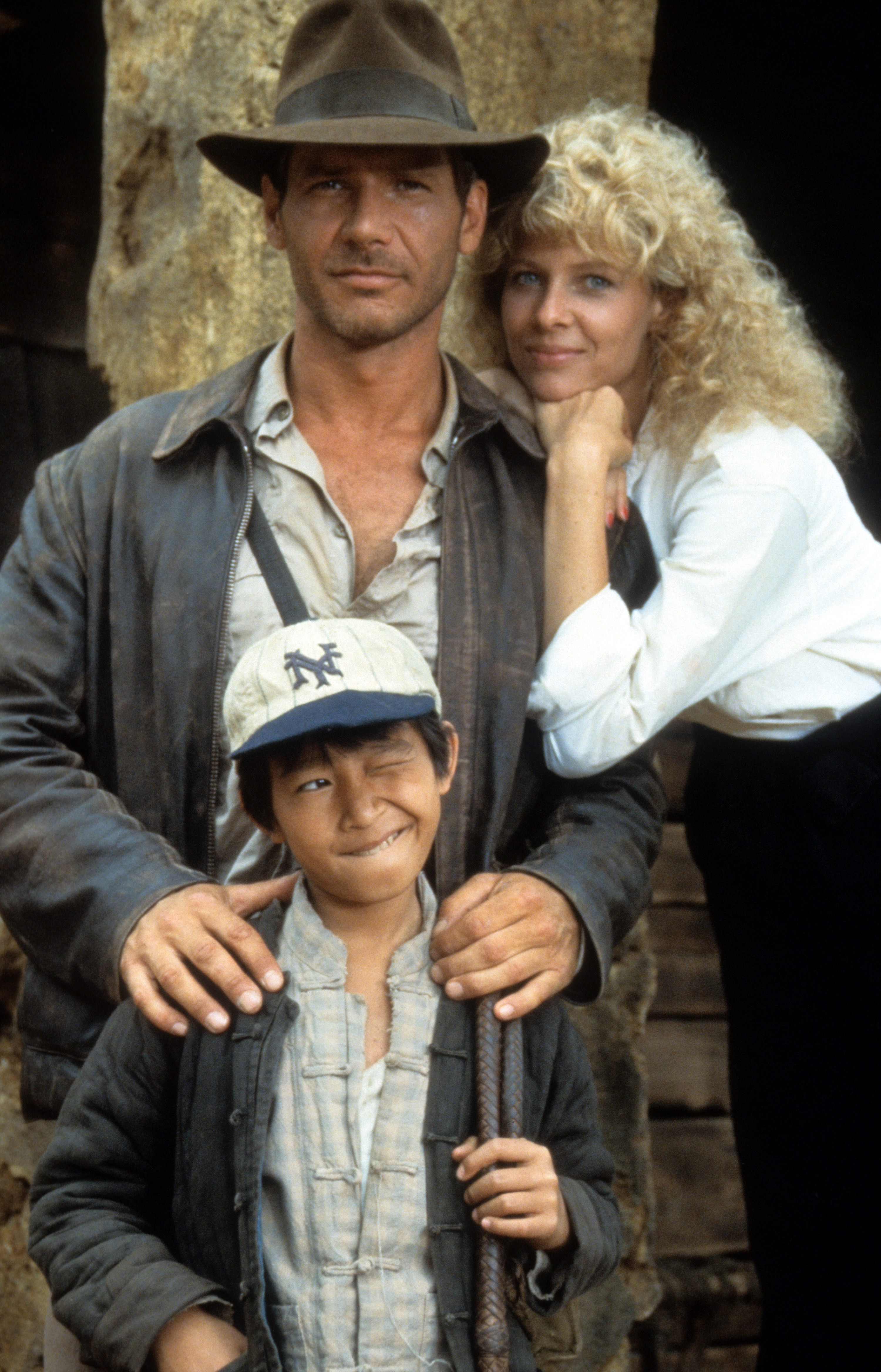 Ke Huy Quan, Harrison Ford, and Kate Capshaw in an Indian Jones movie poster