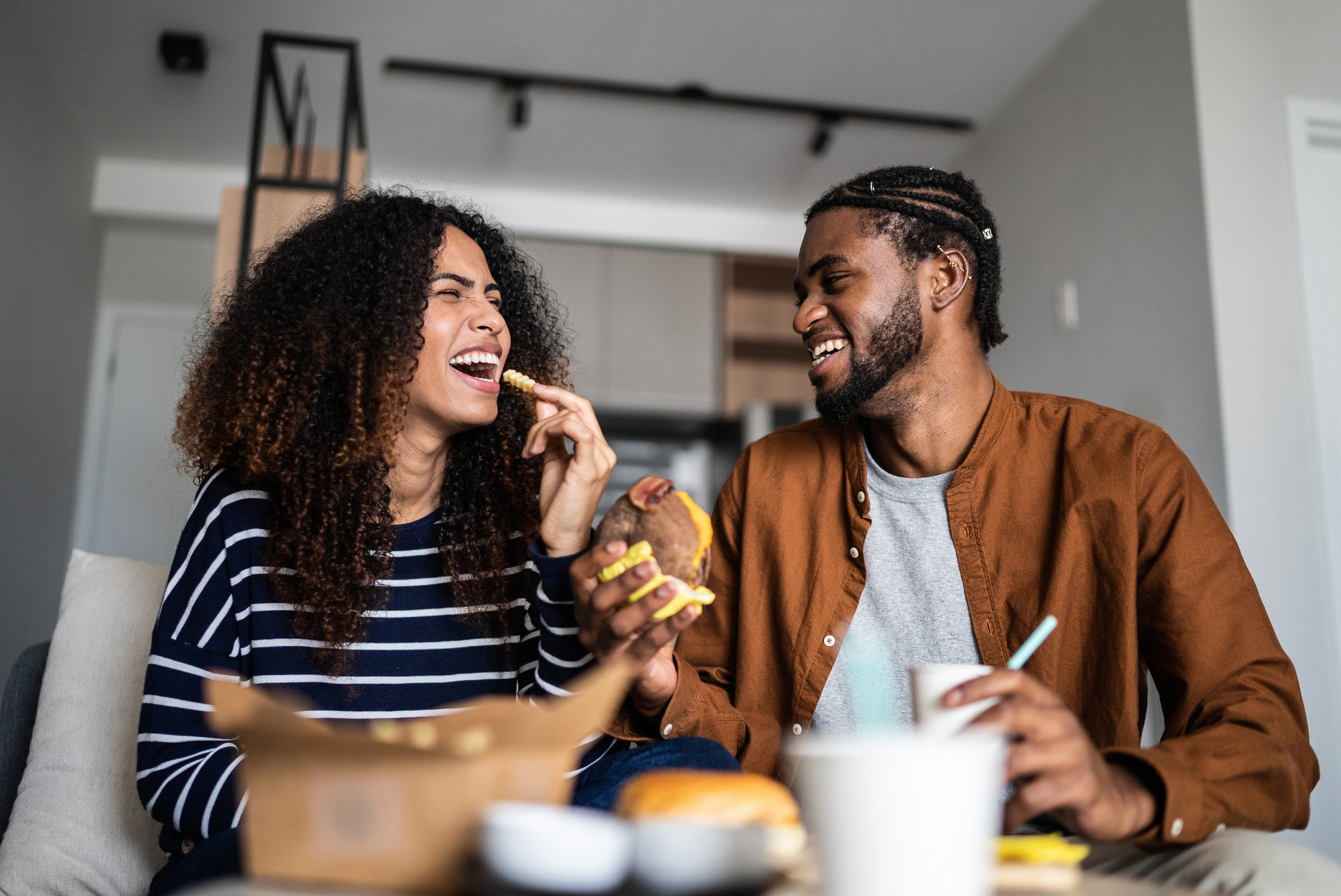 A couple eating snacks together