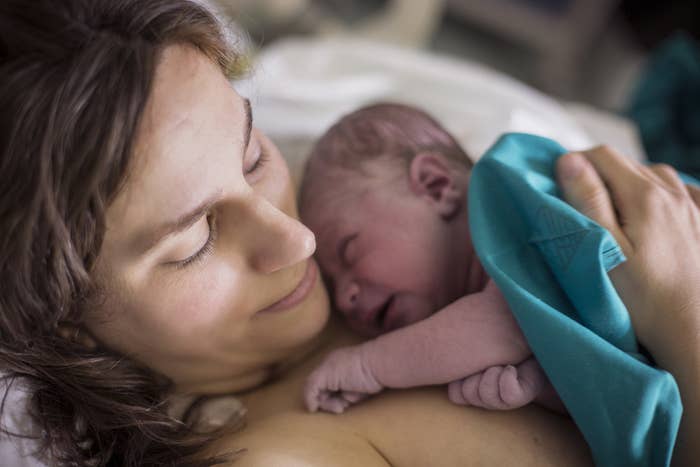 Woman holding newborn baby in hospital