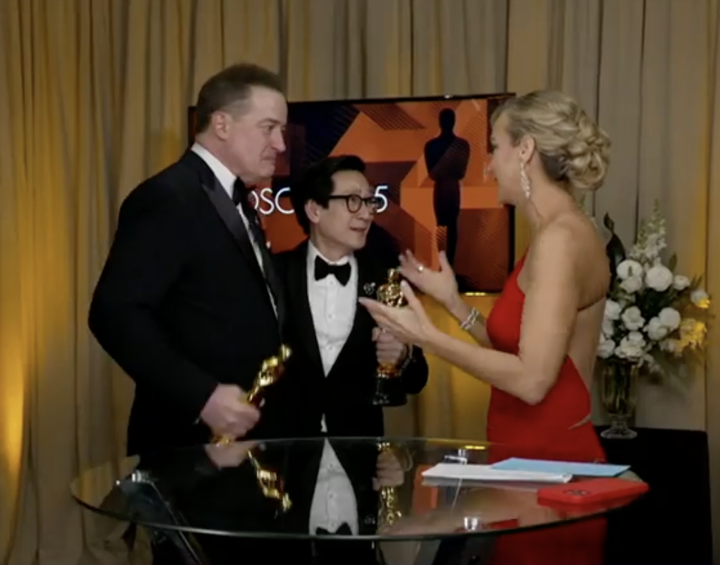 Lara Spenser speaks to Ke Huy Quan and Brendan Fraser backstage at the Oscars