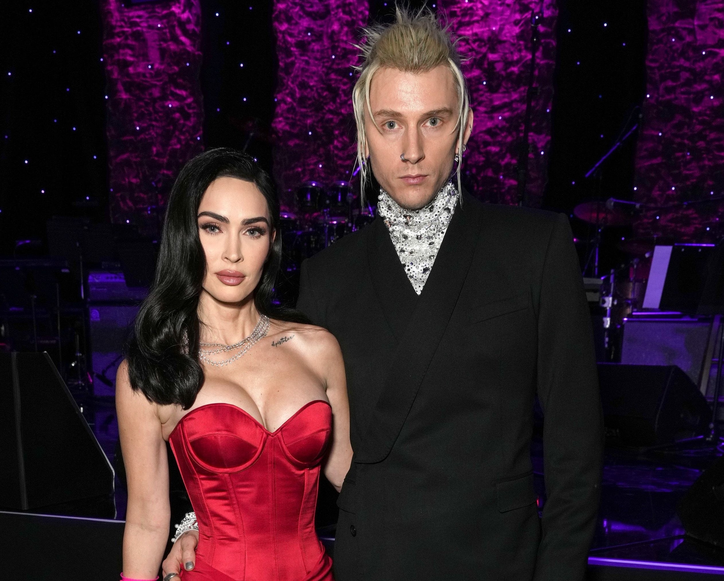 A close-up of Megan and MGK with their arms around each other's waist