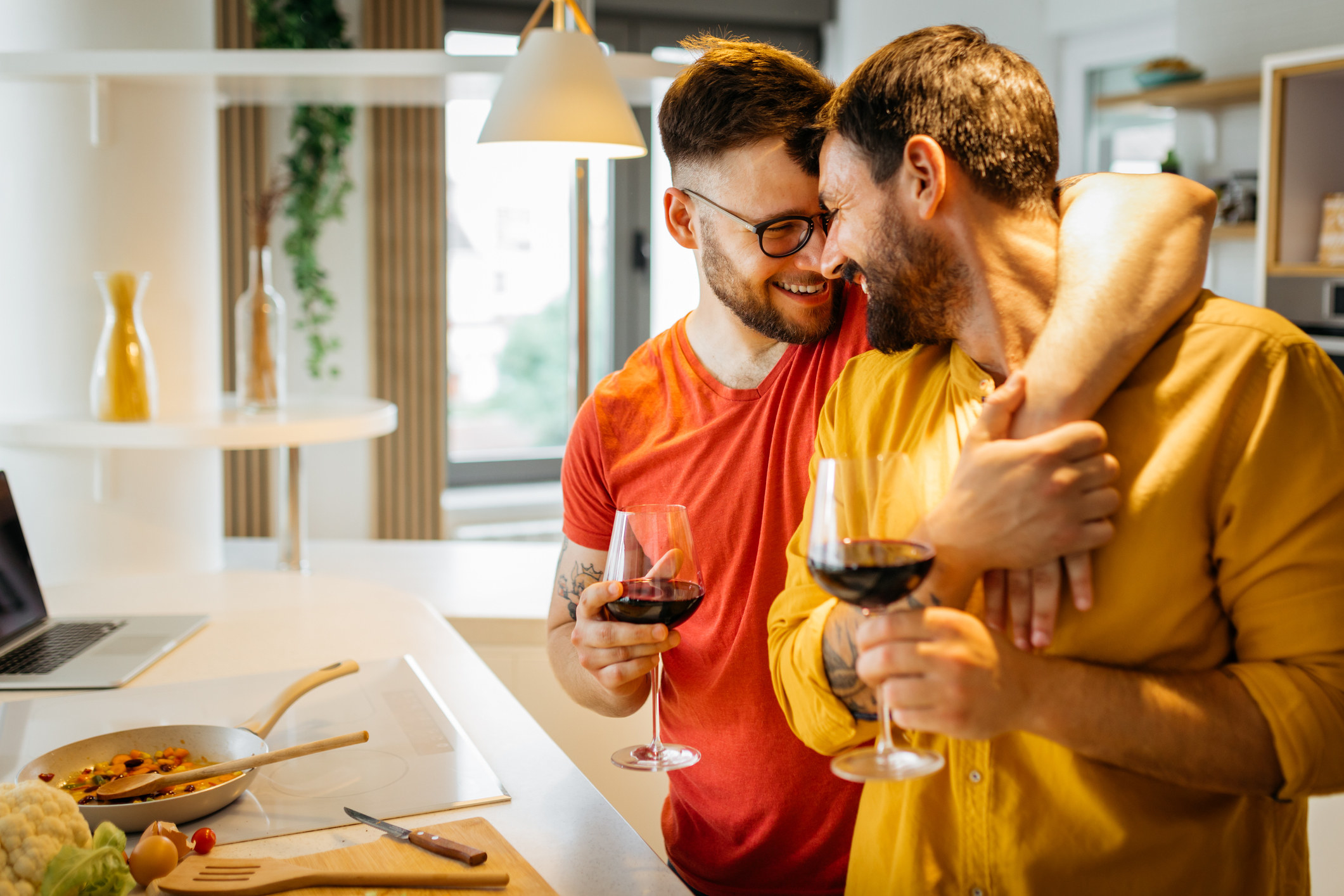 A couple cooking together and drinking wine