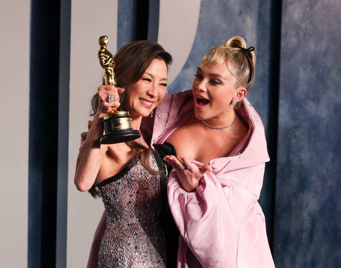 Florence Pugh hugs Michelle Yeoh as she holds up her Oscar