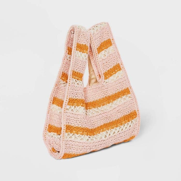 The small crochet bag in a blush, orange, and ivory stripes pattern