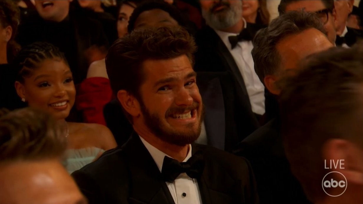 Andrew in a bow tie grimacing in the audience
