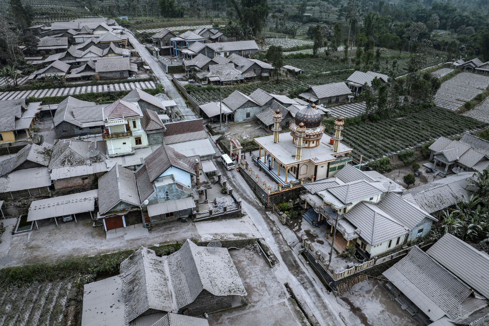 aerial view of a village covered in white ash