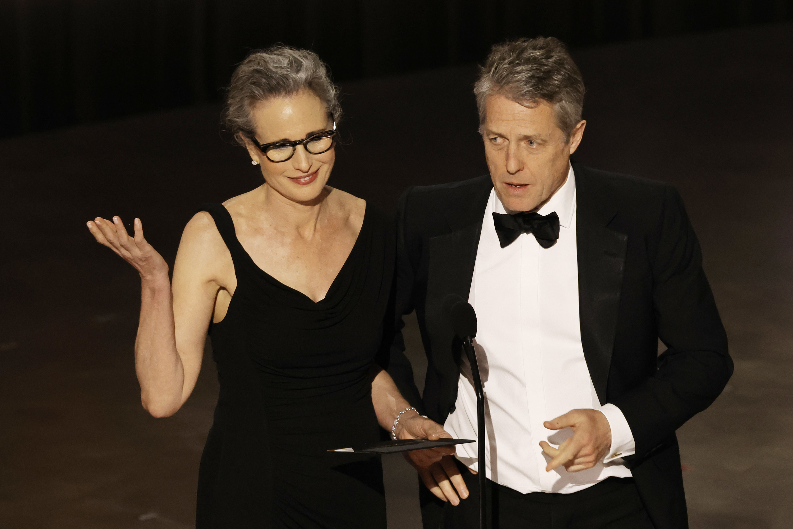Andie and Hugh onstage presenting an award