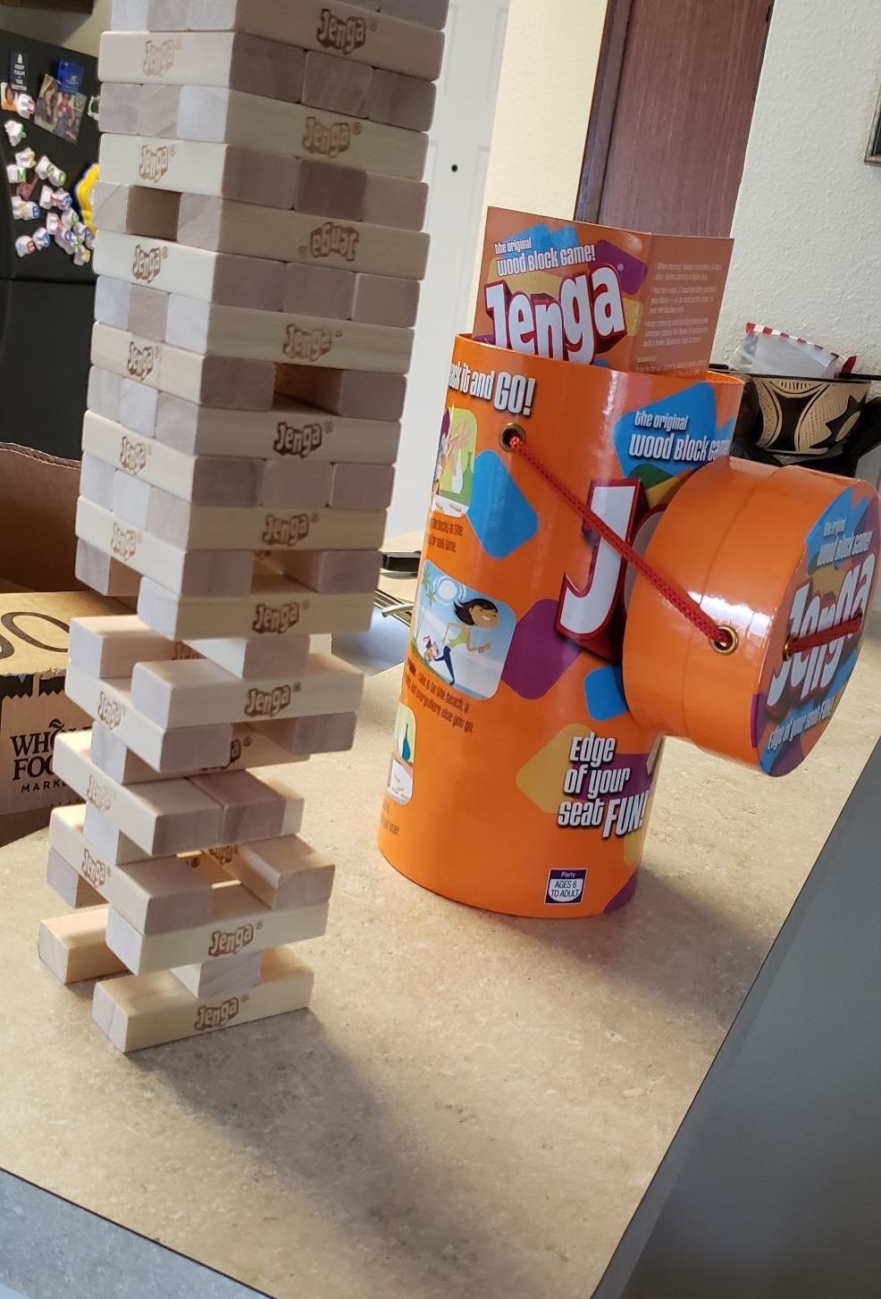 Reviewer&#x27;s photo of of stacked Jenga blocks and carrying case