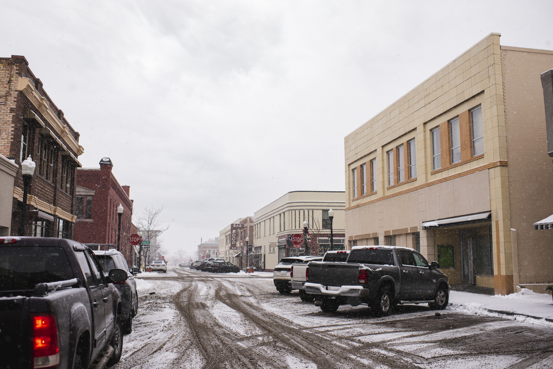 Pick-up trucks parked in a town.