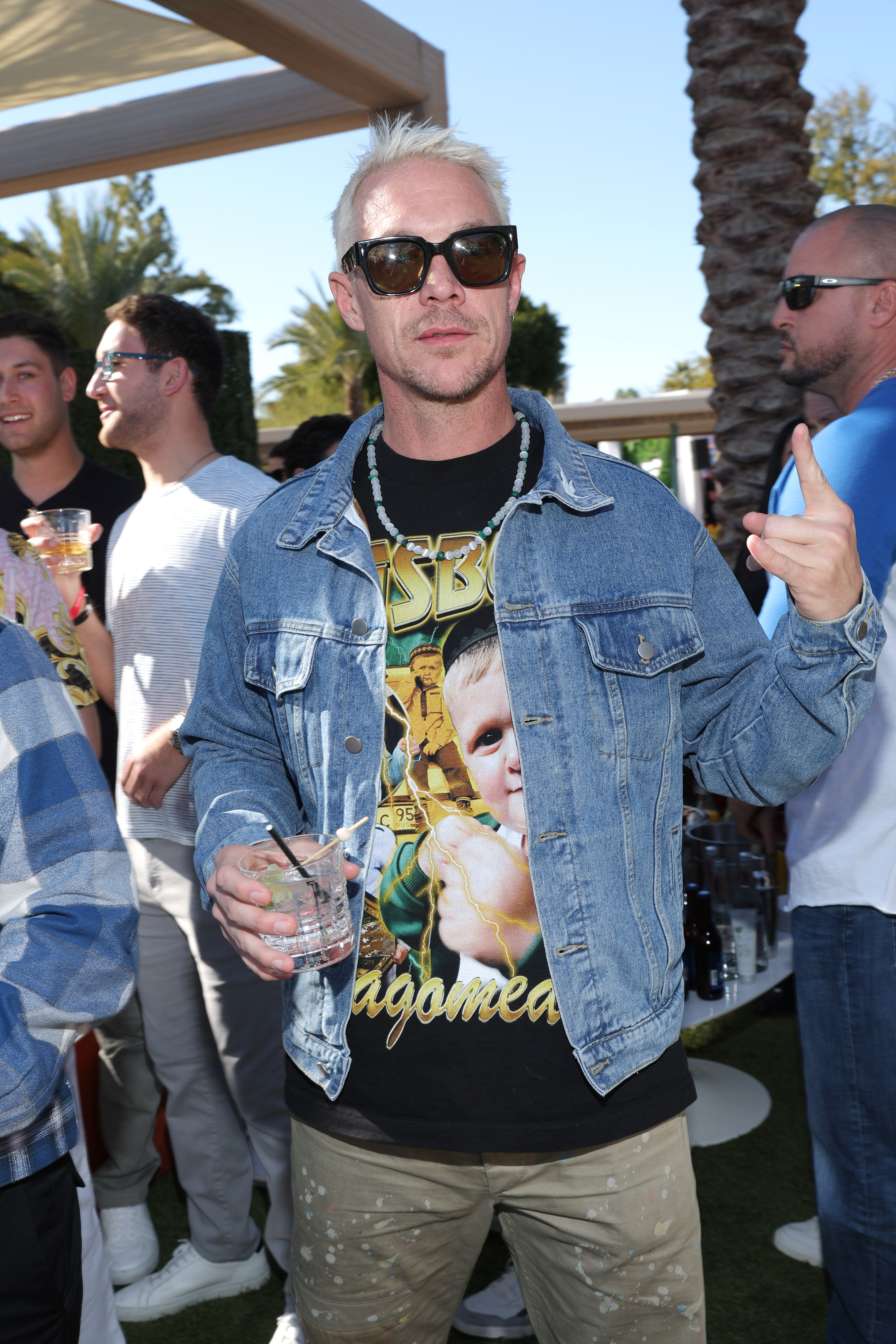 Diplo at an outdoor event holding a drink