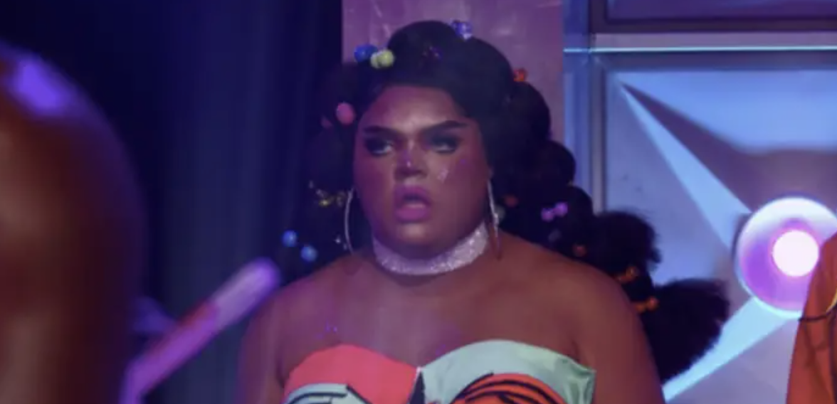A drag performer looking shocked