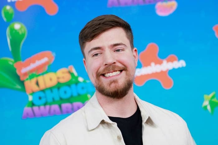 A close-up of MrBeast smiling on the orange carpet of the Nickelodeon Kids&#x27; Choice Awards