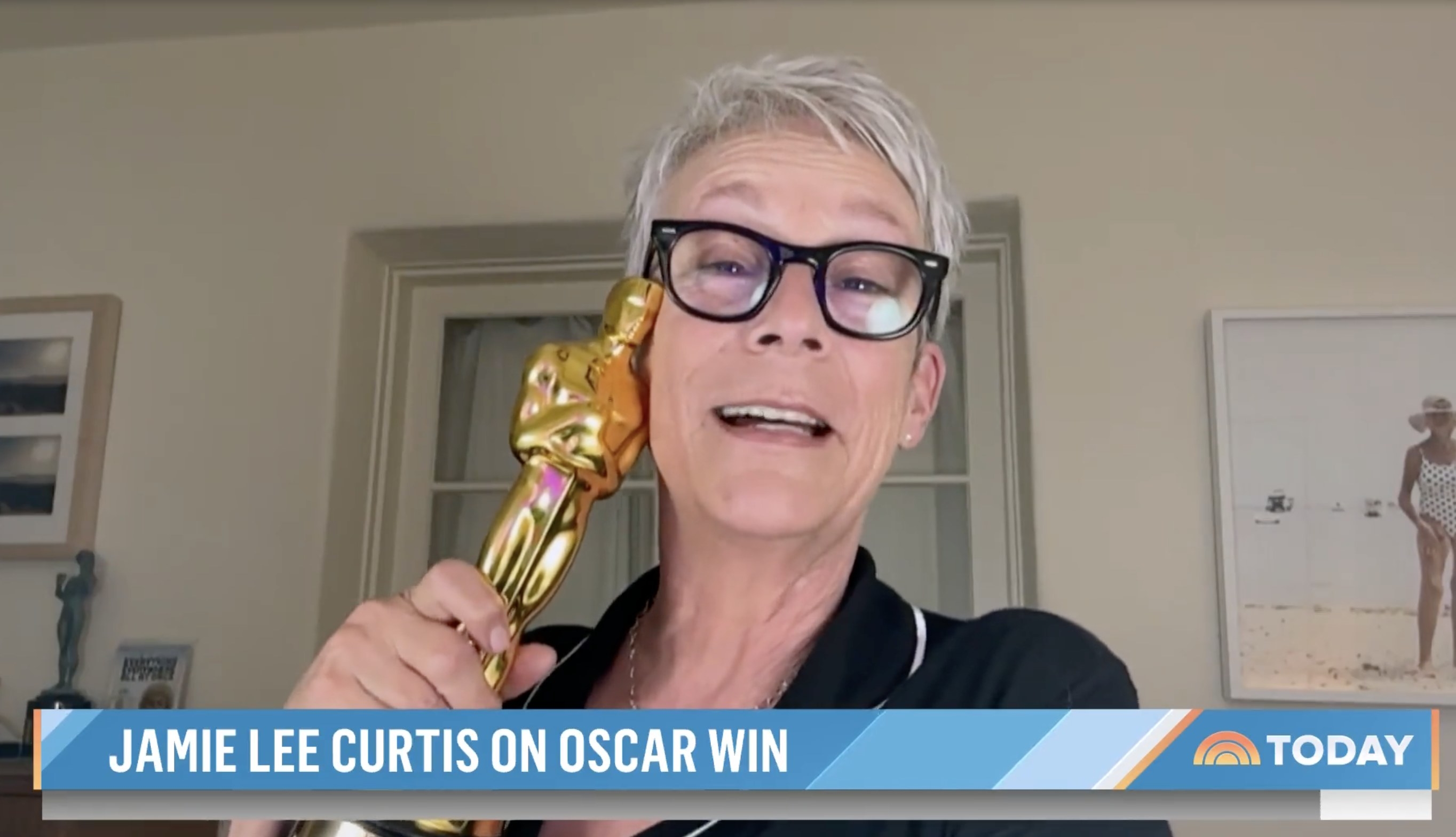 Jamie holds up her Oscar next to her face in her interview