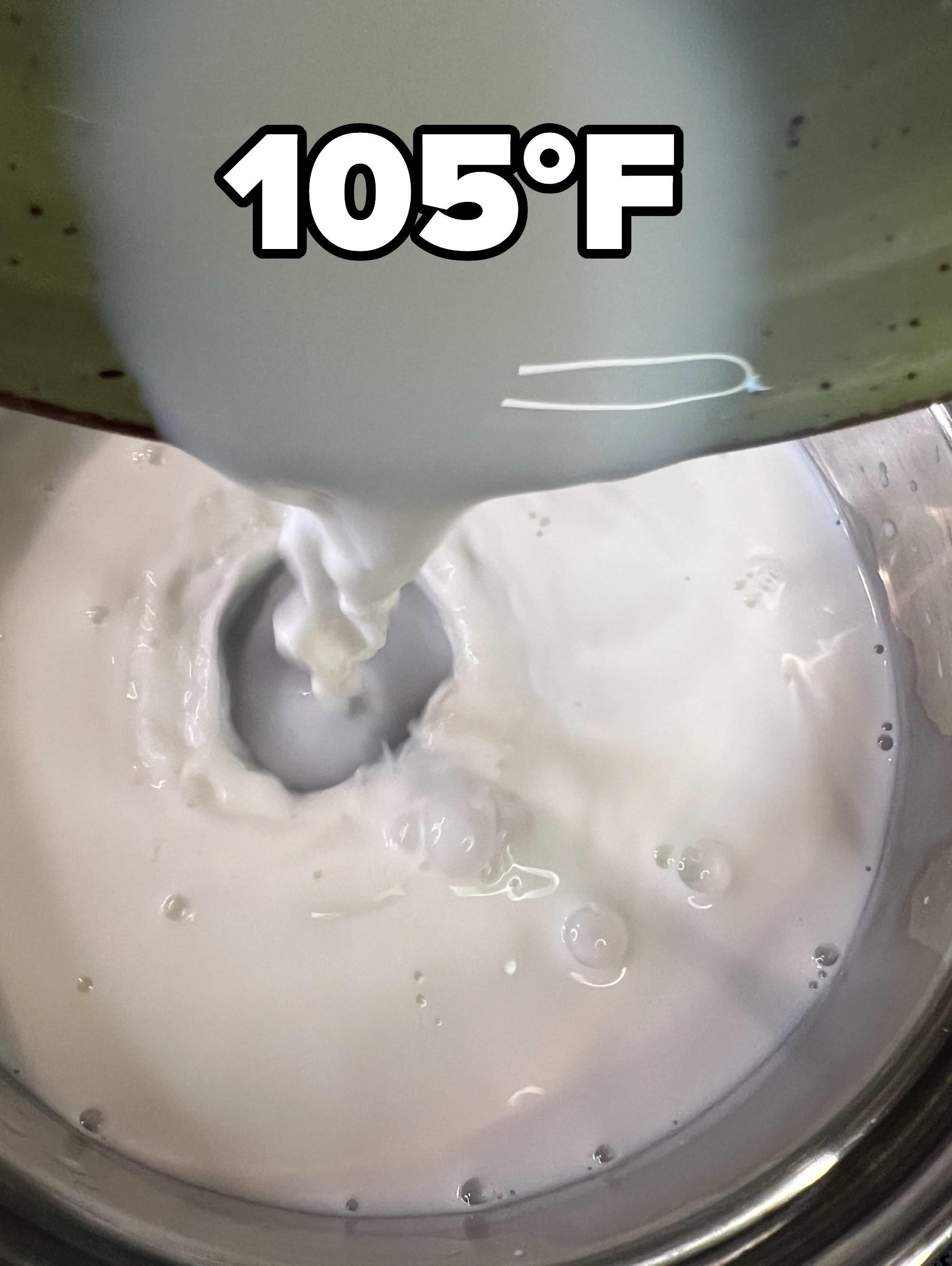 Milk being poured into a pot