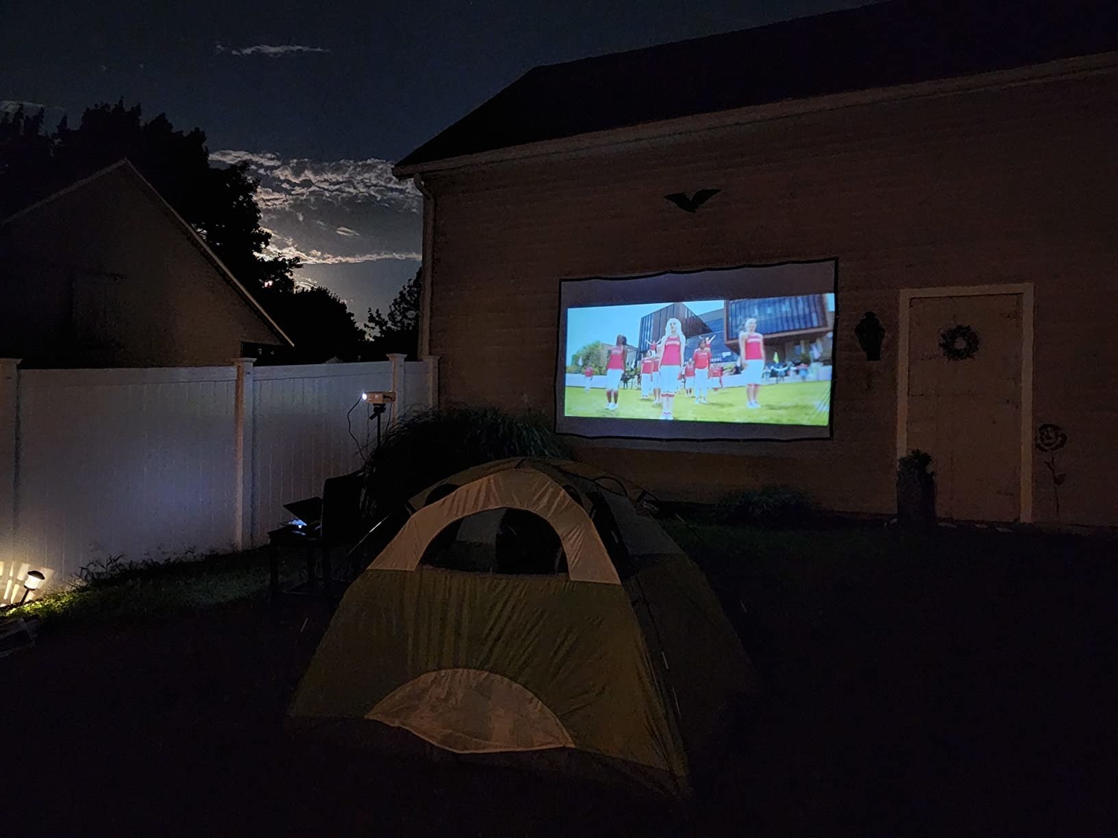Reviewer&#x27;s picture of their projector in a backyard