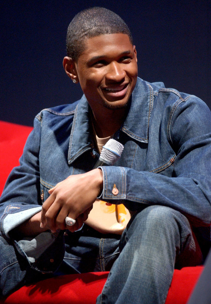 usher sitting on a couch wearing all denim