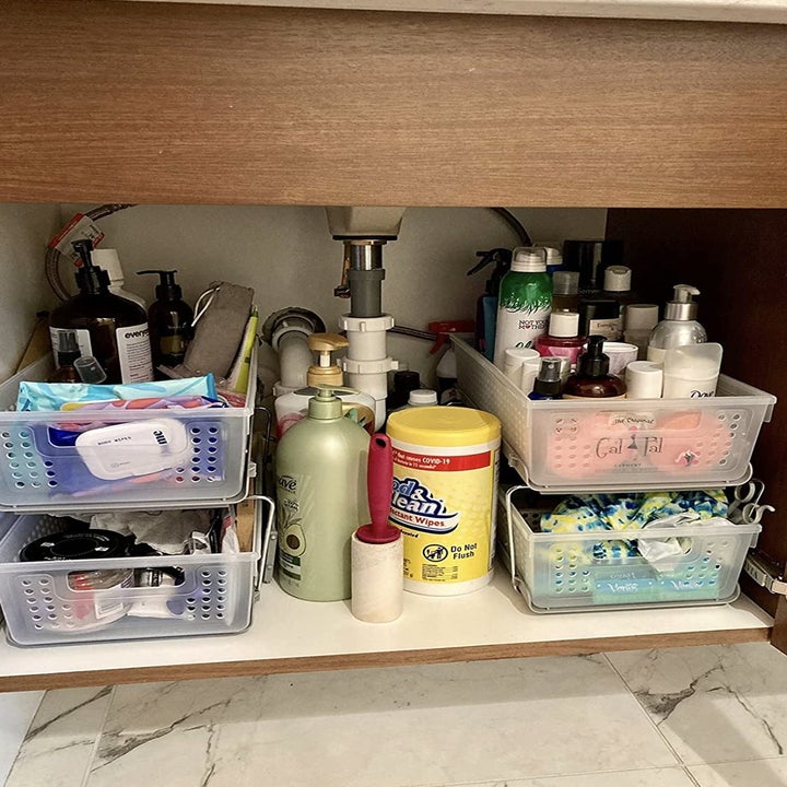 same reviewer showing their under-sink storage completely organized with the plastic bins