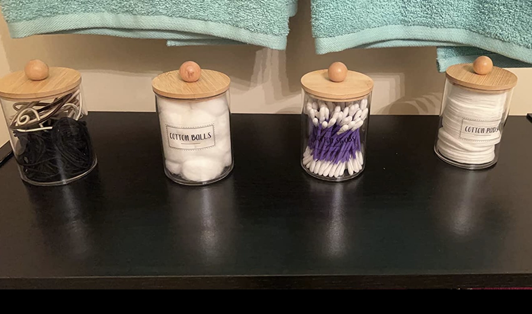 reviewer photo showing the bathroom organizer jars filled with q-tips, cotton rounds, and more