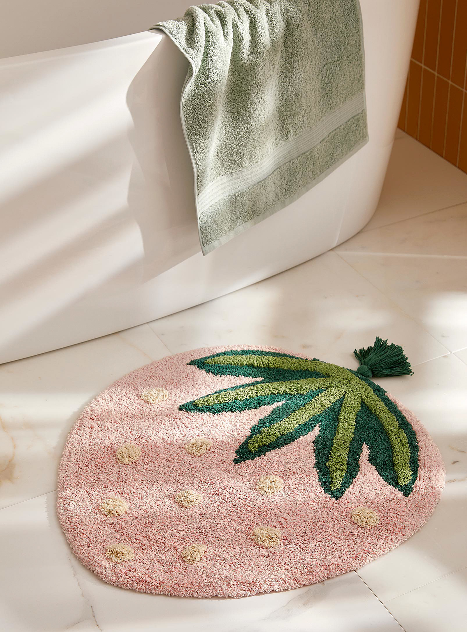 the bath mat on the floor of a bathroom