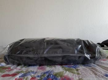 reviewer photo showing their items in a space saver bag before vacuuming out the air