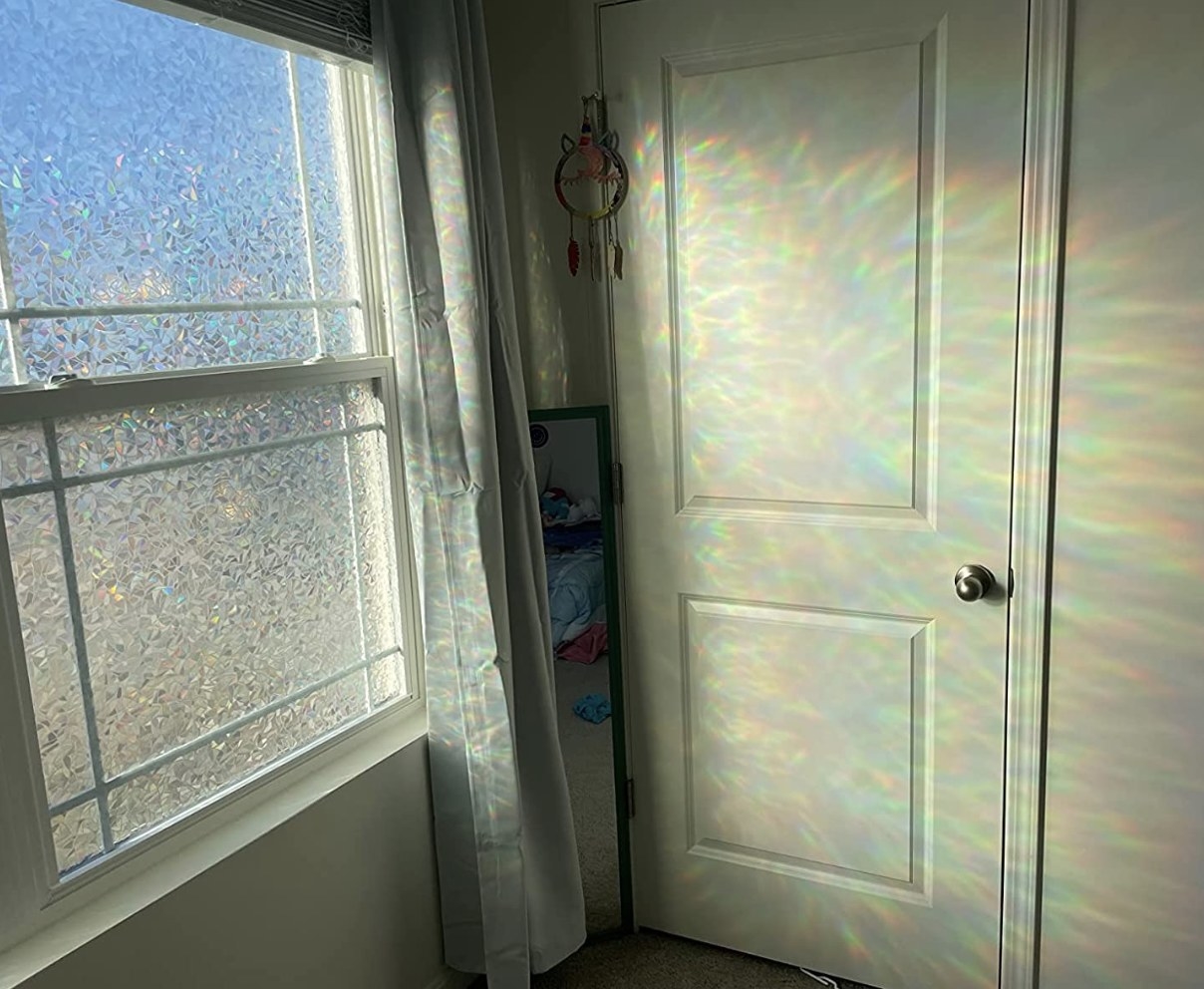 A photo of the product on a window creating rainbows