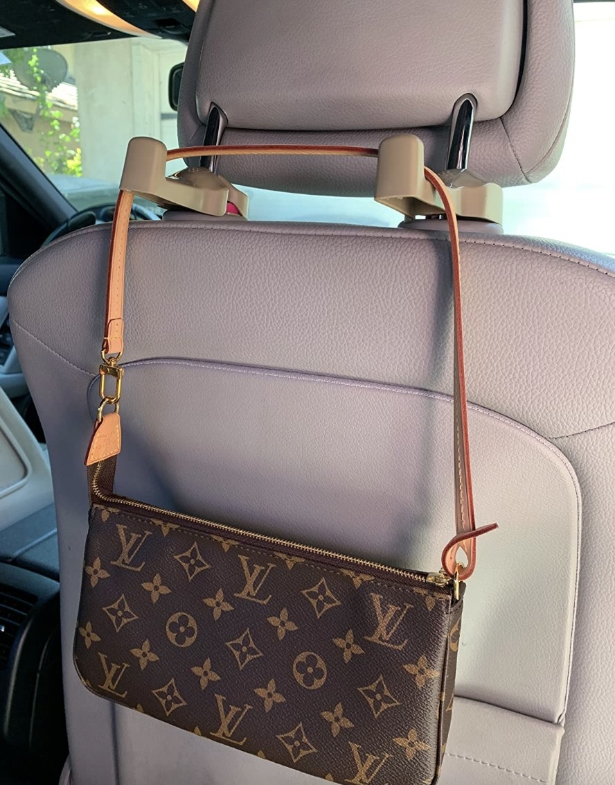 A photo of the product with a purse hanging from it