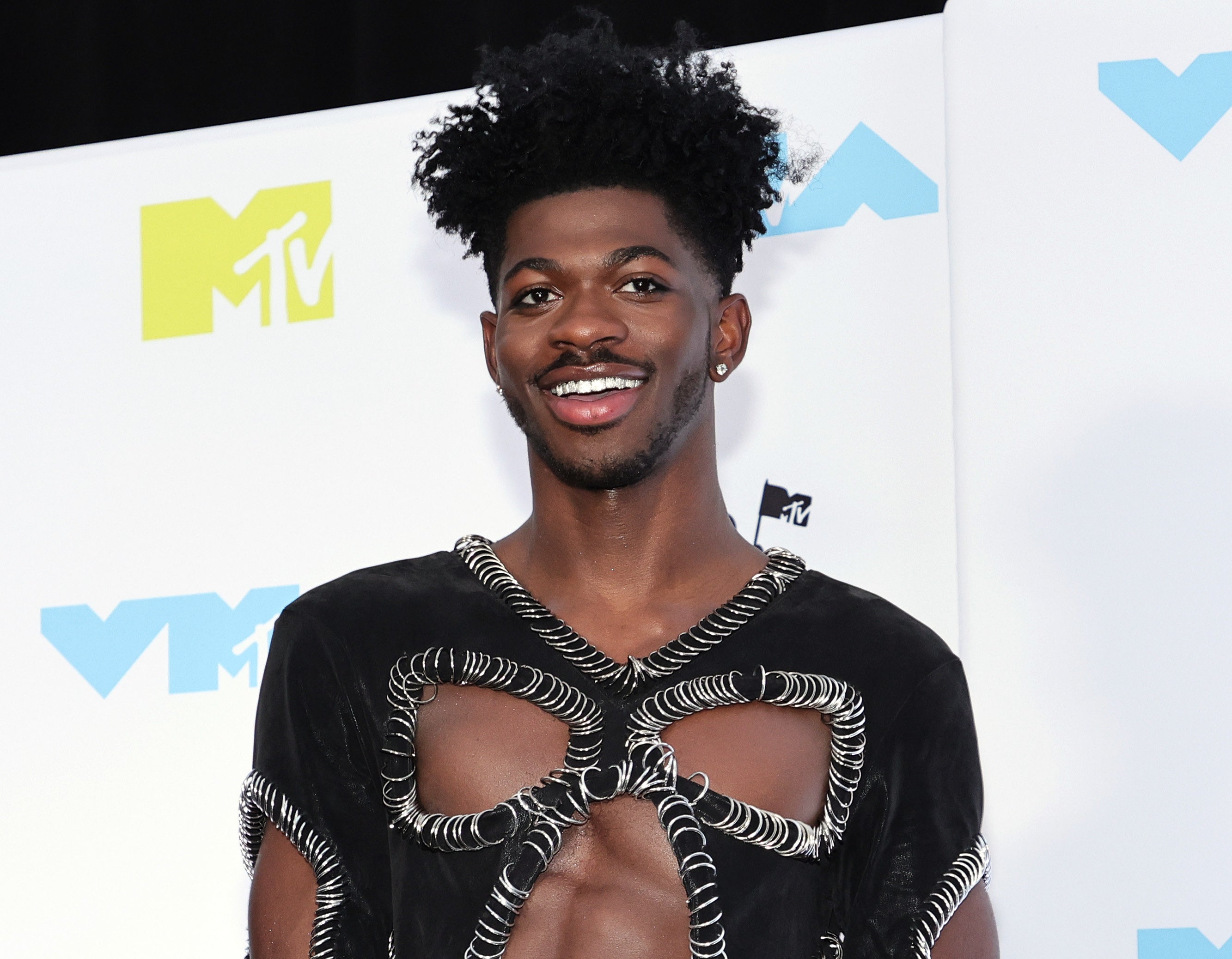 A close-up of Lil Nas smiling