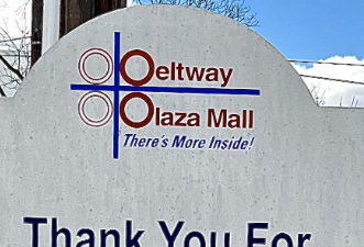 An illegible logo for Beltway Plaza Mall