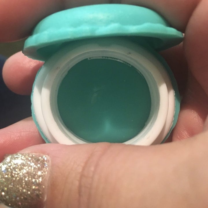 reviewer holding the macaron case with the lid open