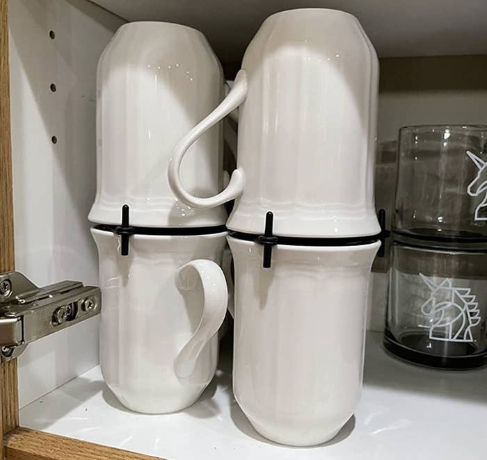 reviewer photo showing mug organizer with four mugs in their shelves